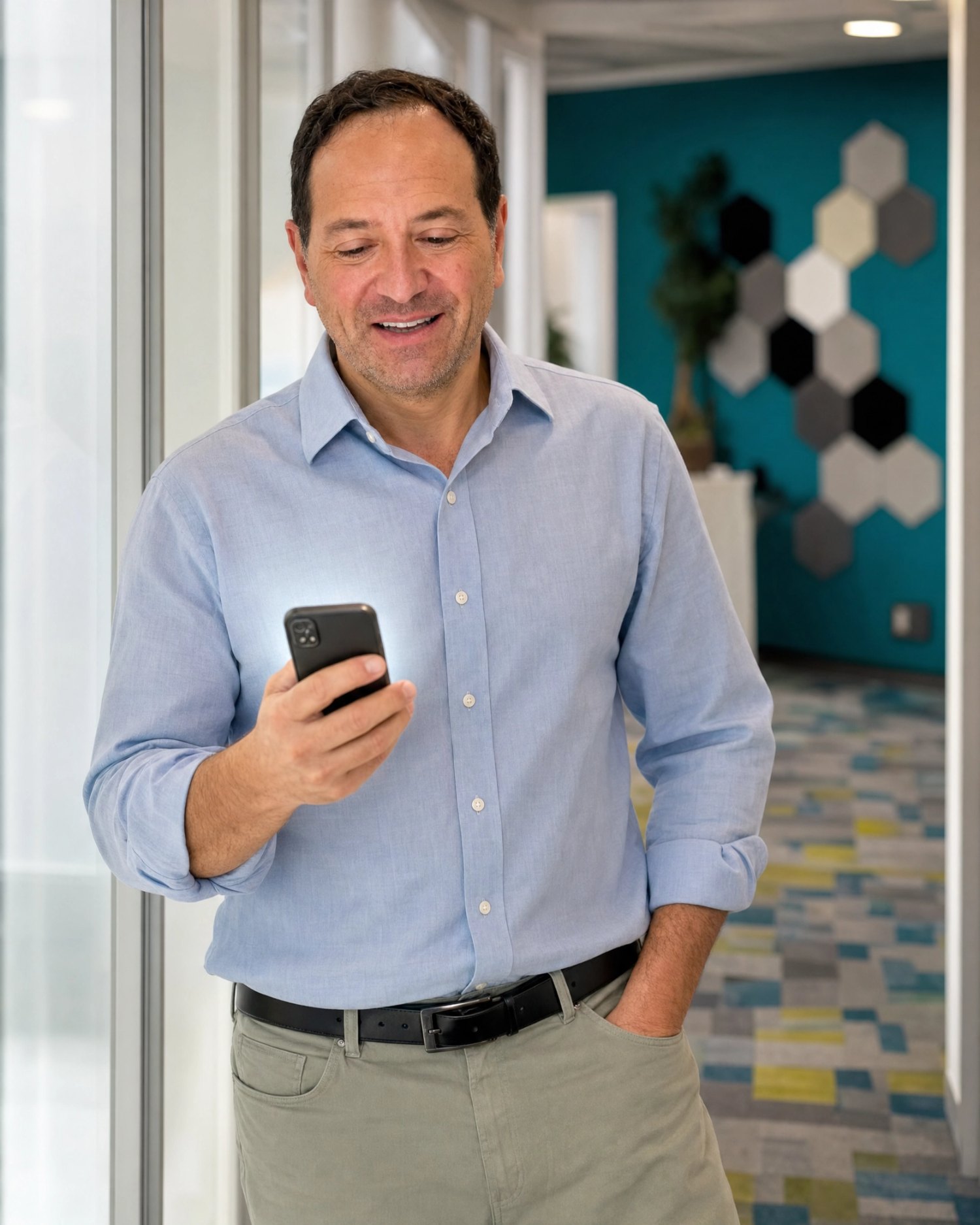 Marc Apple checking his phone at the Forward Push office